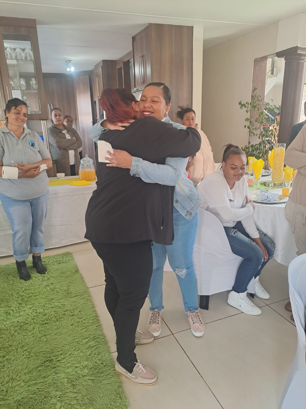 Women embracing at a Lighthouse Foundation gathering